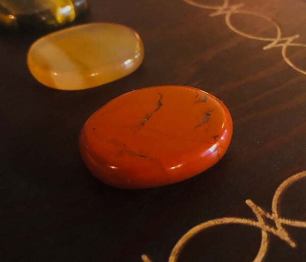 These are the seven chakra healing gem stones and crystal we used in the immersive chakra alignment therapy group class "The 49 Professions of Joy" by personal trainer Jack Kirven. This one is red jasper.